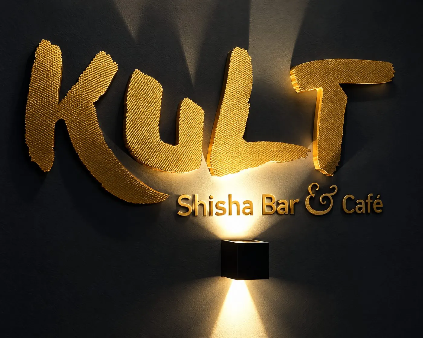 Goldenes KULT-Logo an der Wand